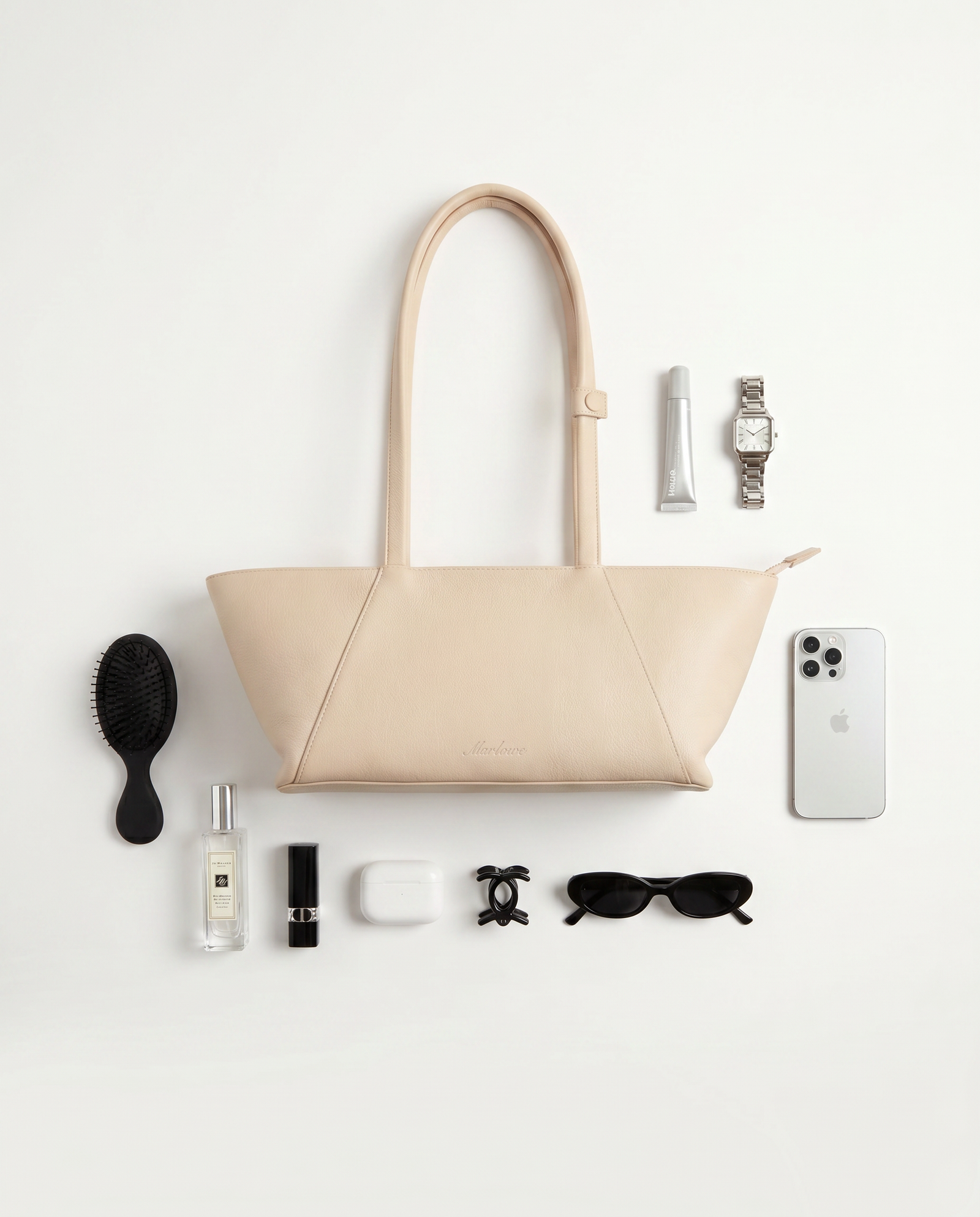 Flat lay of the Kells with a wallet, phone, keys and a lipstick